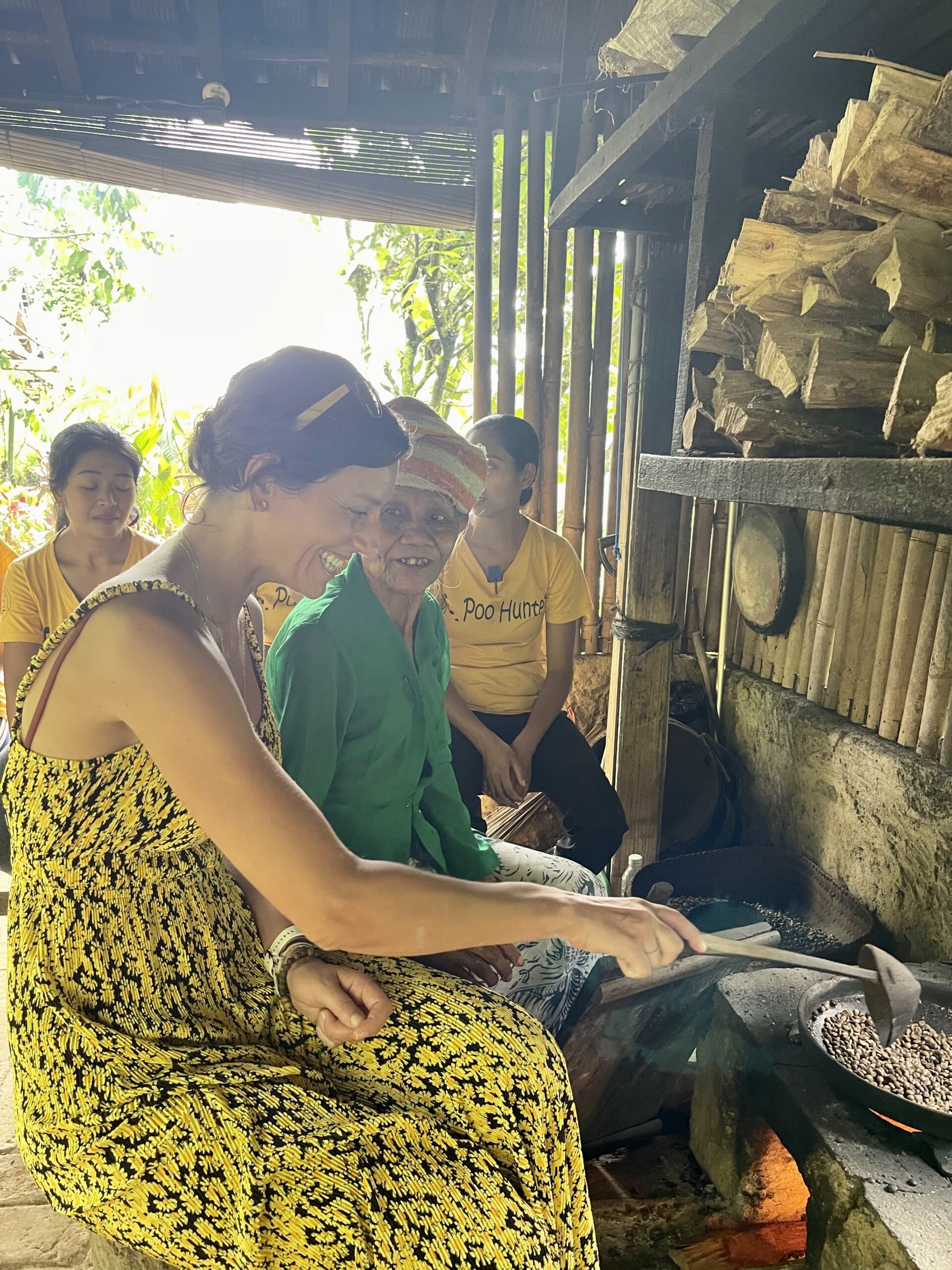 Moment d’échange autour de la torréfaction du café avec une femme locale, symbolisant la connexion humaine et la magie des échanges authentiques