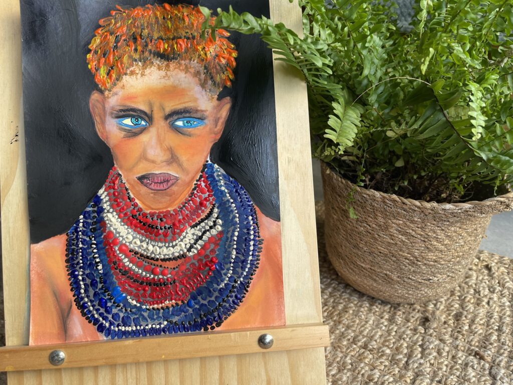 Peinture d’un personnage chamanique avec un regard perçant, réalisée par Céline, fondatrice d’Immersive Expérience, pour exprimer sa créativité et son amour pour les tribus aborigènes comme les Masai.