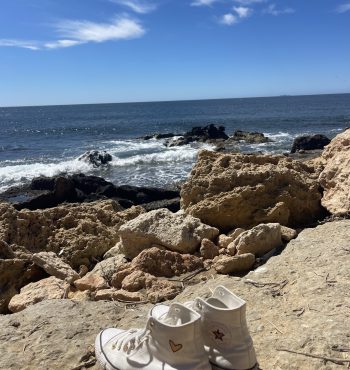 Bord de mer à Caro, La Couronne, avec des chaussures posées, ciel bleu et soleil radieux”